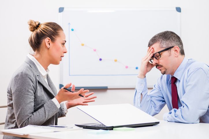 business woman firing her male colleague