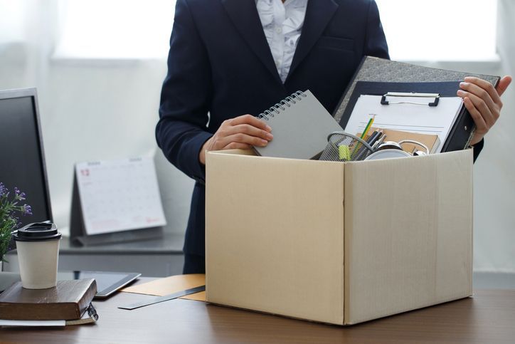 businesswoman packing her personal belongings in a box